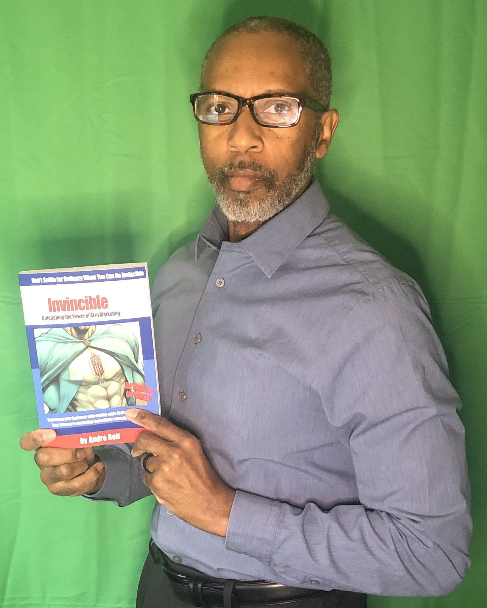 business growth consultant Andre Bell holding one of his books